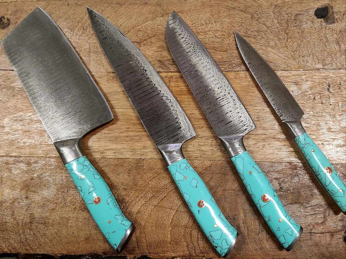 The 5-piece turquoise kitchen set from Rugged Edge Blades laying on a butcher block.