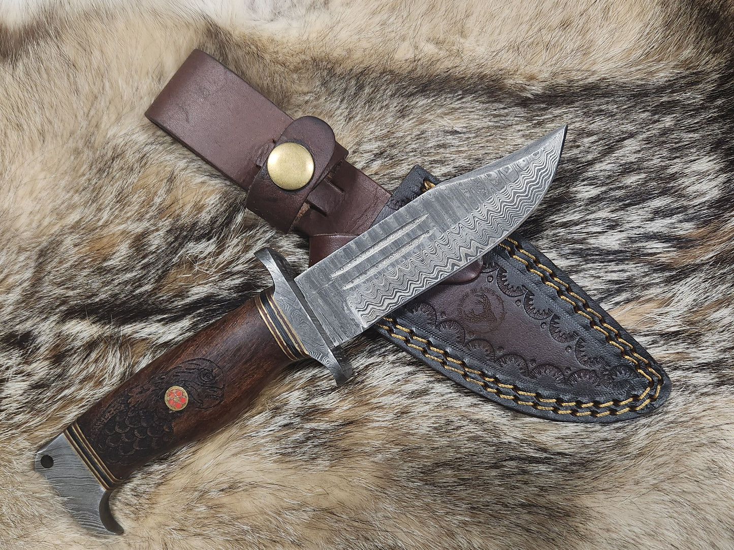 Eagles Valor hunting collectible knife with Damascus steel blade, engraved wooden handle, and tooled leather sheath.