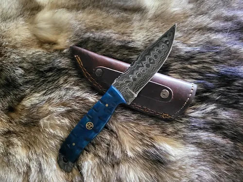 The Carved Blue Everyday Cary Knife from Rugged Edge Blades laying on its custom leather sheath built for safe and easy carrying.