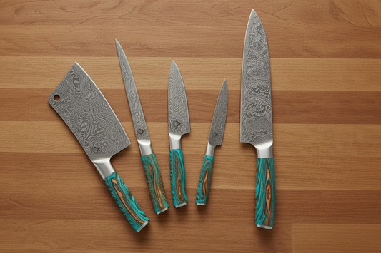 A teal-handled kitchen set of custom damascus steel knives including a chef knife, a cleaver, a boning knife, and pairing knife.
