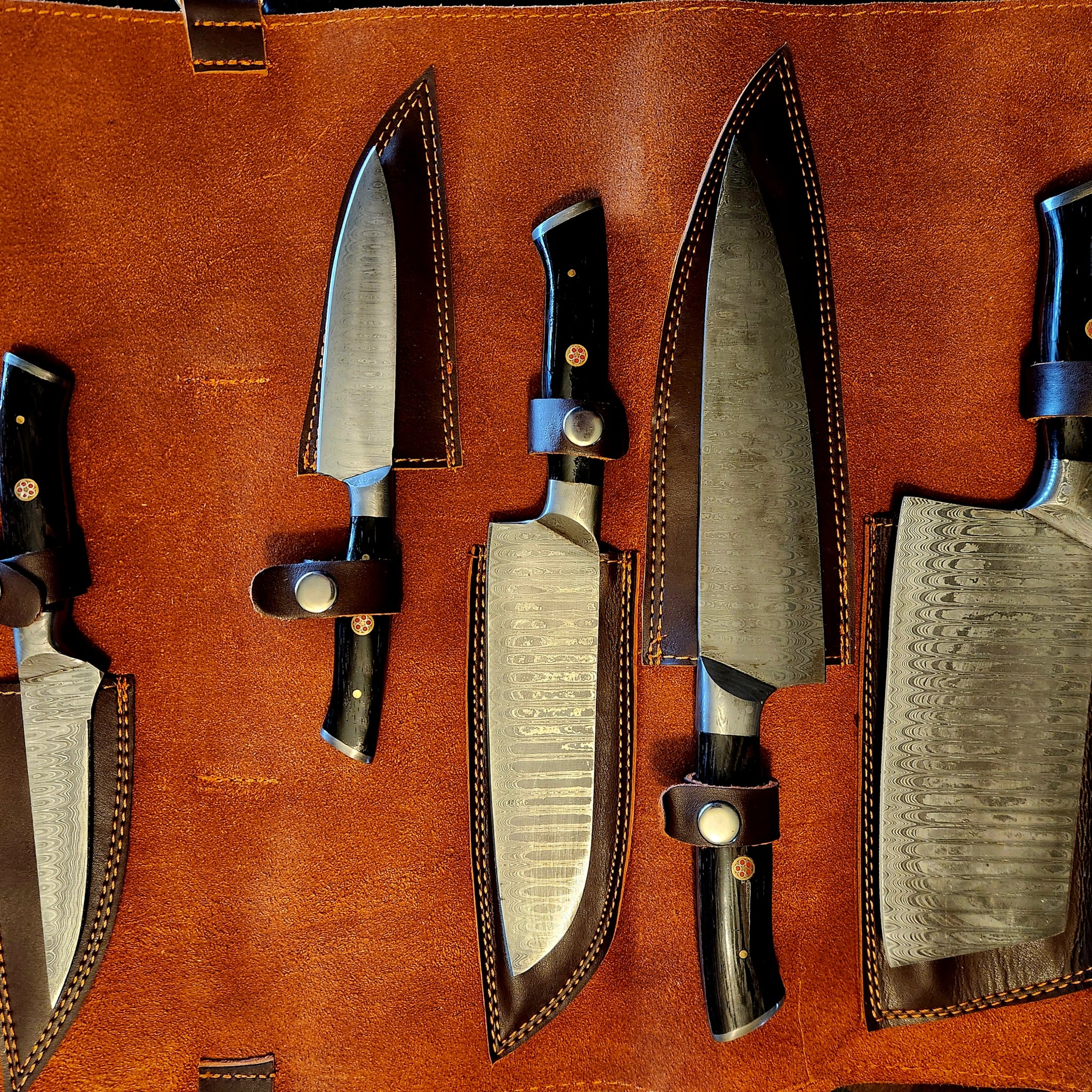 Black 5 pc Kitchen Set featuring premium chef's knives with black handles in a brown leather roll case. Ideal for professional and home kitchens.
