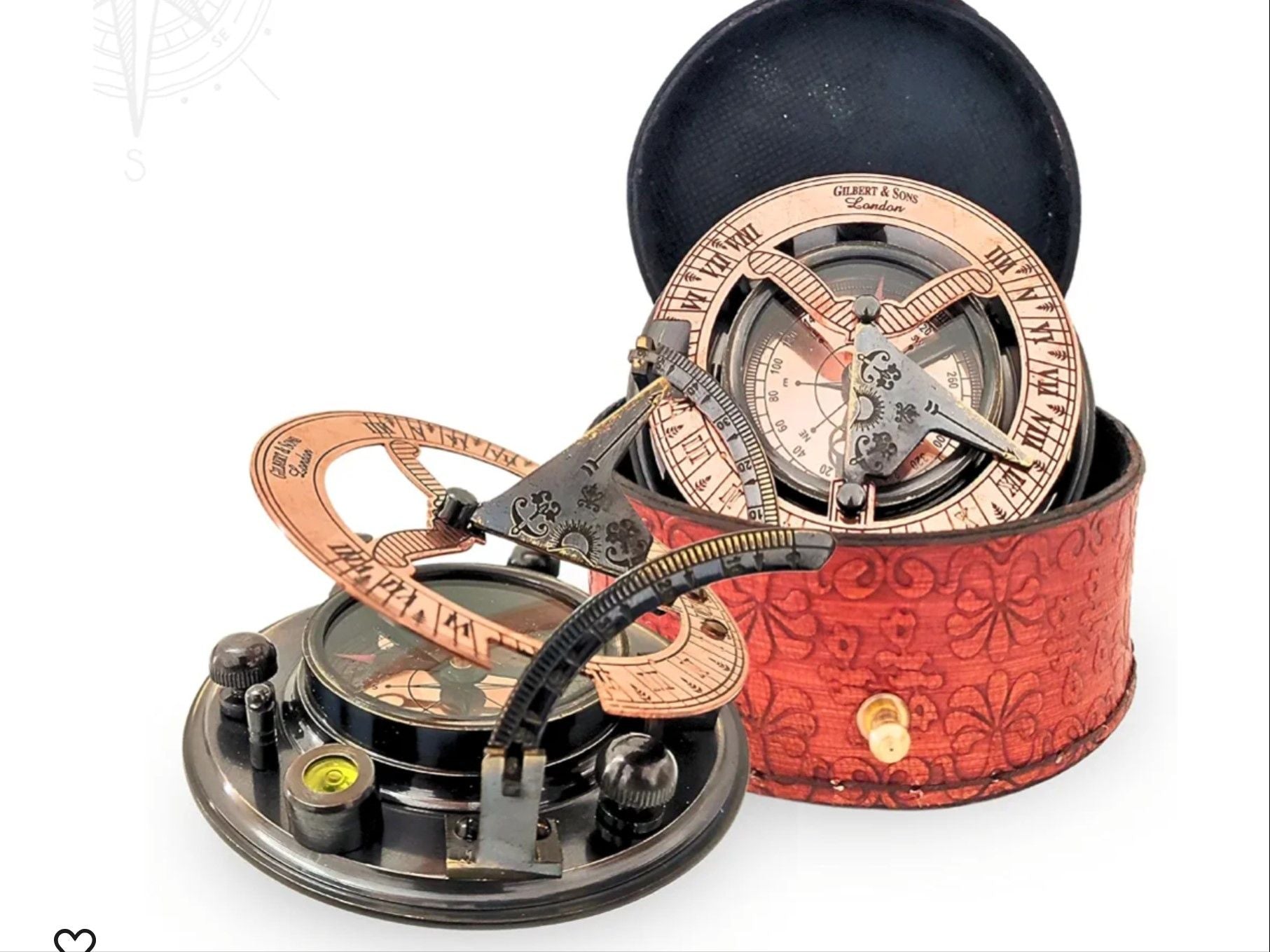 Vintage-style magnetic navigational compass with intricate copper detailing and directional arms, housed in a red leather case for camping and hiking.