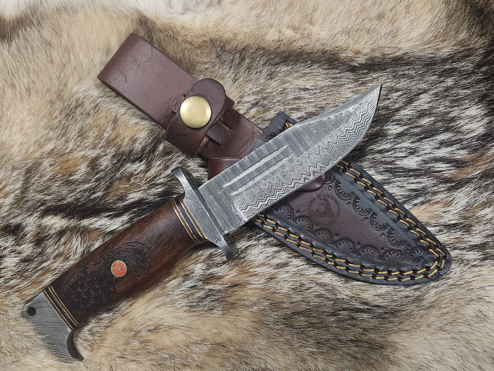 Eagles Valor hunting collectible knife with Damascus steel blade, engraved wooden handle, and tooled leather sheath.