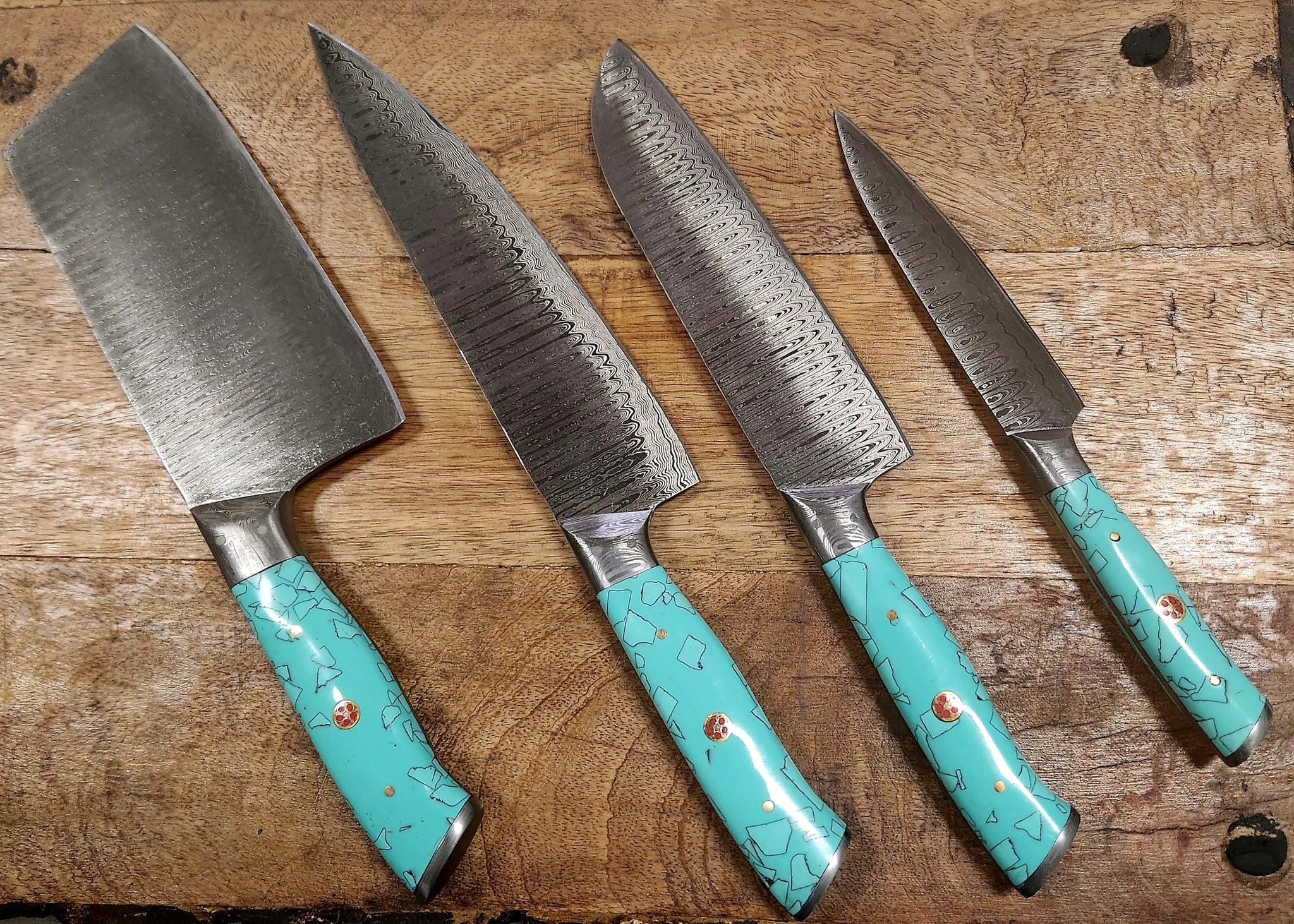 5 Piece Turquoise Kitchen Set featuring five stainless steel knives with patterned blades and ergonomic turquoise handles.