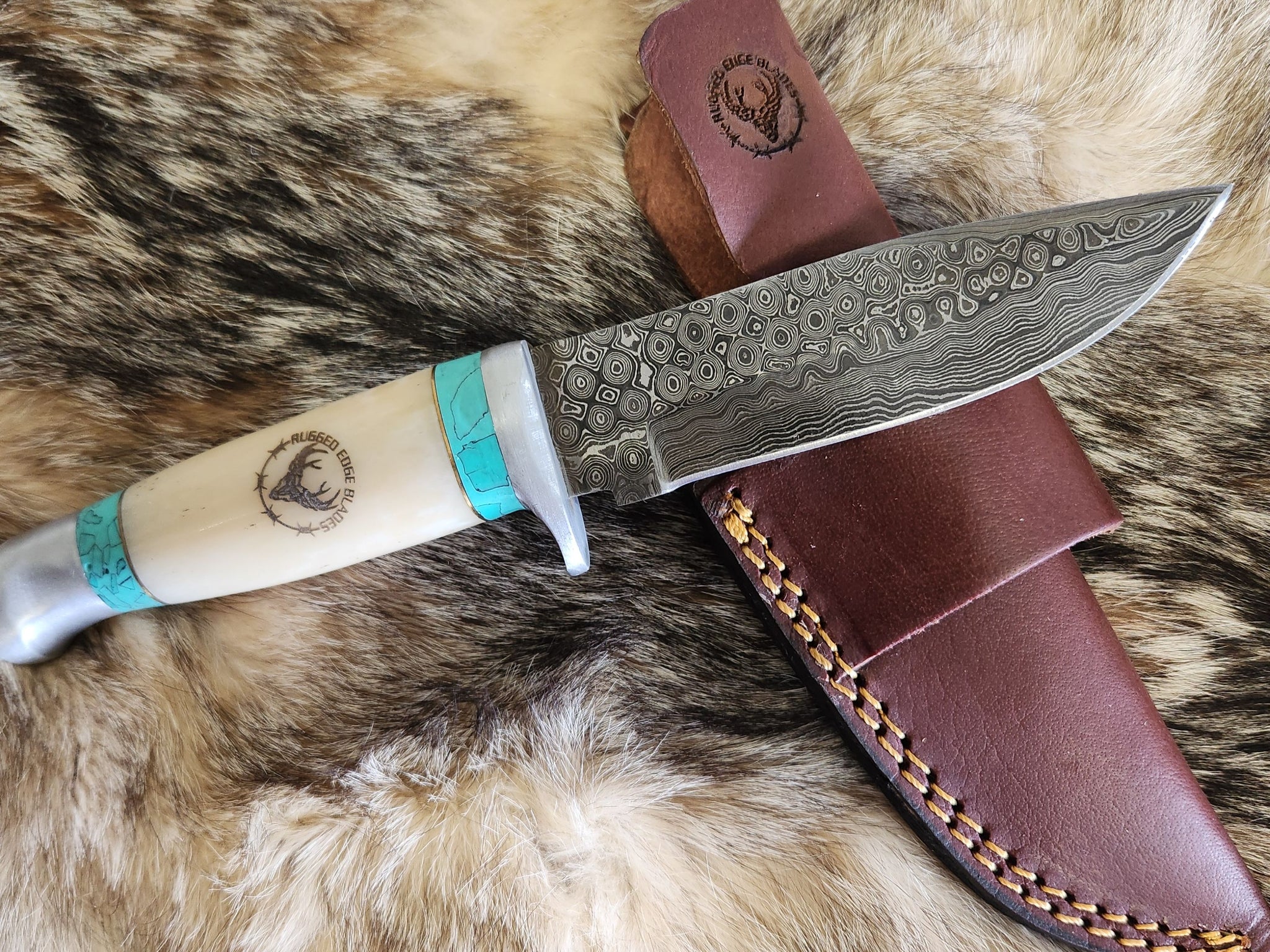 Azure and Bone Damascus knife with polished bone handle, turquoise accents, and patterned steel blade, displayed with leather sheath.