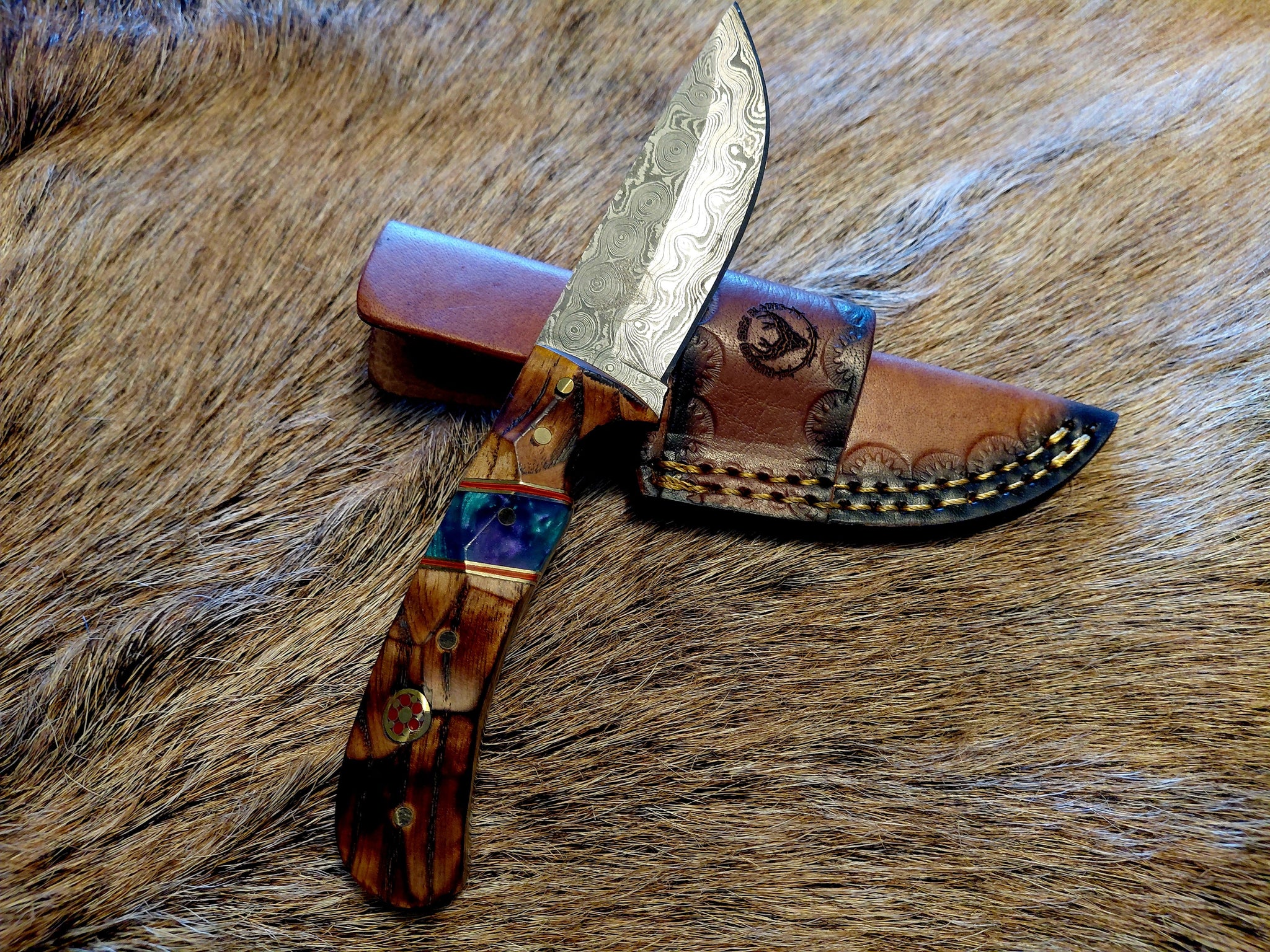 Decorative knife with a wooden handle on a fur background
