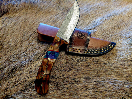 Decorative knife with a wooden handle on a fur background